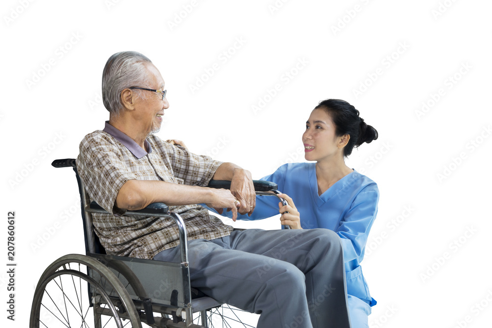 Senior man talking with his nurse on studio Senior man talking with his nurse on studio