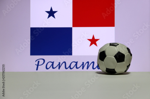 Small football on the white floor and panamanian nation flag with the text of Panama background. The concept of sport, Panama is one of the finalists in football tournament of the world.
