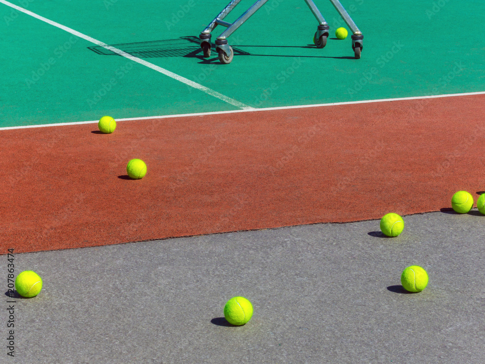 Yellow tennis balls on the tennis field. Big tennis