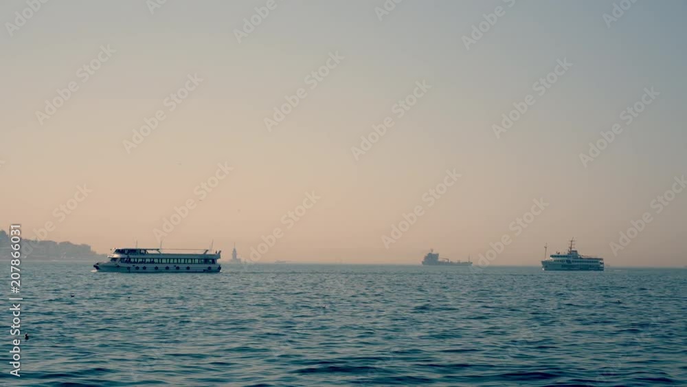 ISTANBUL, TURKEY - APRIL, 24, 2018: Ships sailing through the Bosporus in the daytime ISTANBUL, TURKEY - APRIL, 24, 2018: Ships sailing through the Bosporus in the daytime