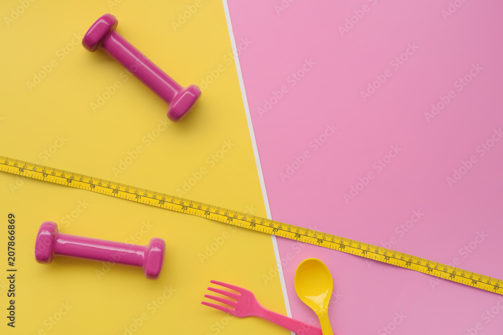 close up of spoon in tape measure with dumbbell for background close up of spoon in tape measure with dumbbell for background