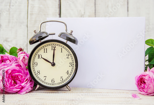 Alarm clock 10 hours. Flowers. Selective focus. 