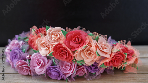Beautiful floral wreaths on a wooden table on a black background
