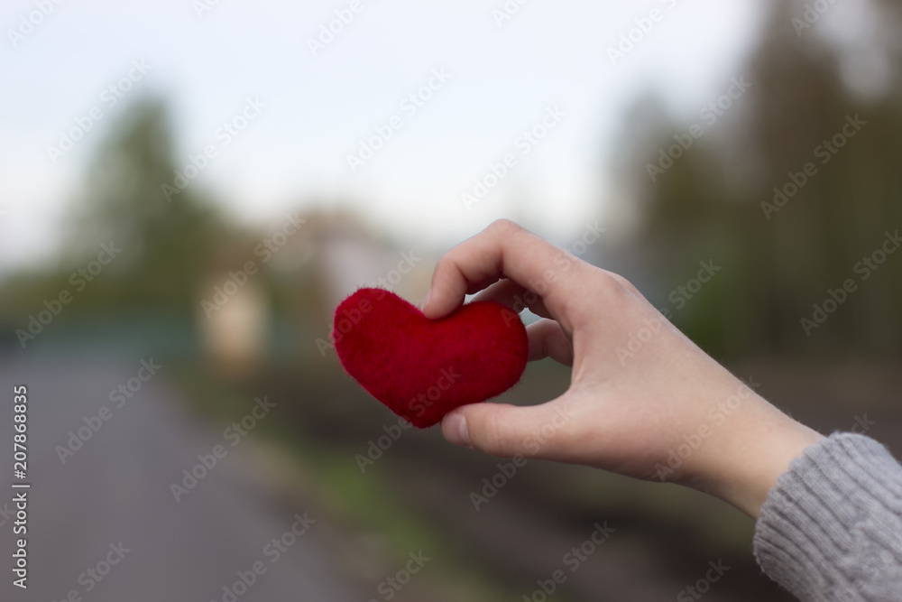 Children's hands giving red heart Children's hands giving red heart