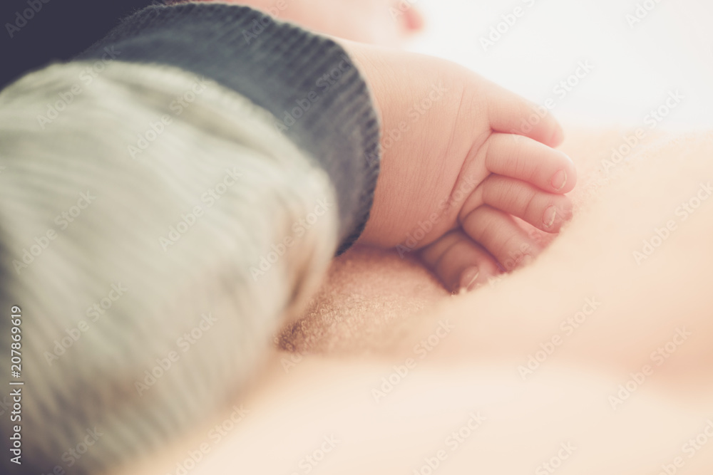 Asian baby on a white blanket - tiny baby feet closeup Asian baby on a white blanket - tiny baby feet closeup