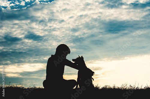 Silhouette cute boy and dog playing at sky sunset in holiday © sawitreelyaon