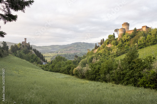 Green valley in italian hills with two castles