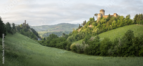 Green valley in italian hills with two castles