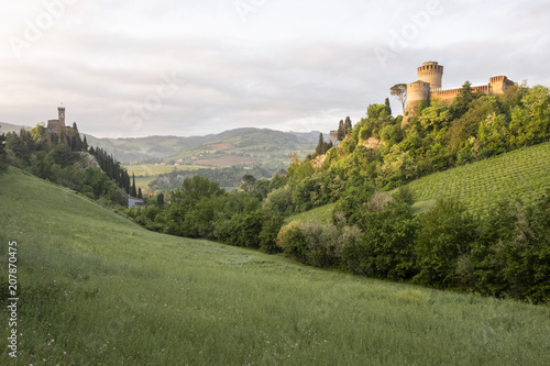 Green valley in italian hills with two castles