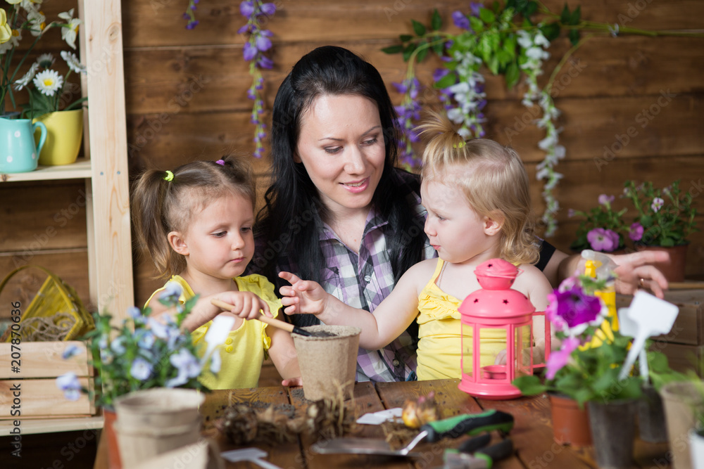 Mom and children are planting flowers Mom and children are planting flowers