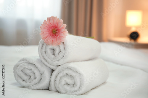 Clean towels on bed in hotel room