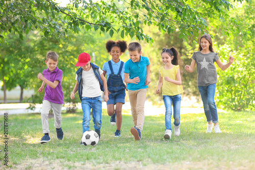 Cute little children playing with ball outdoors on sunny day