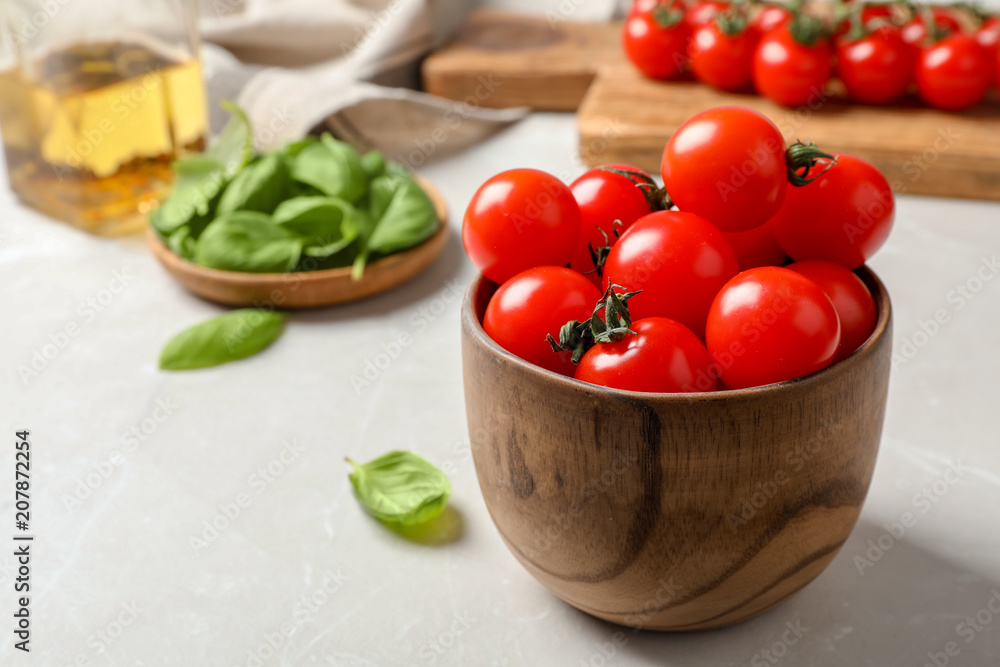 Bowl with ripe red tomatoes and basil on table Bowl with ripe red tomatoes and basil on table