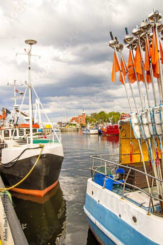 Fishing port of Ustka, Poland with old lighthouse photo