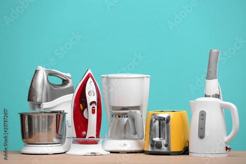 Принти на полотні Household and kitchen appliances on table against color background