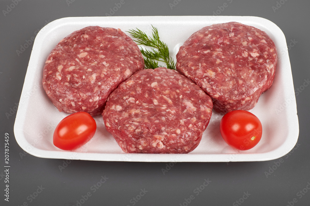 beef burgers in plastic package isolated on white background beef burgers in plastic package isolated on white background