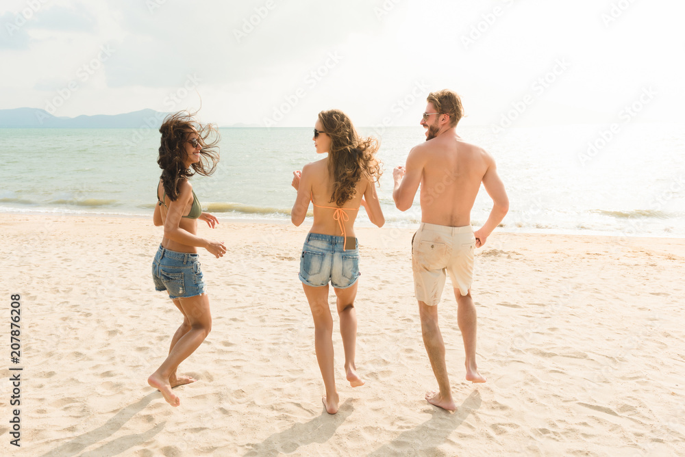 Group of friends enjoying summertime at the beach