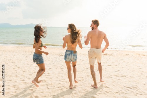 Group of friends enjoying summertime at the beach