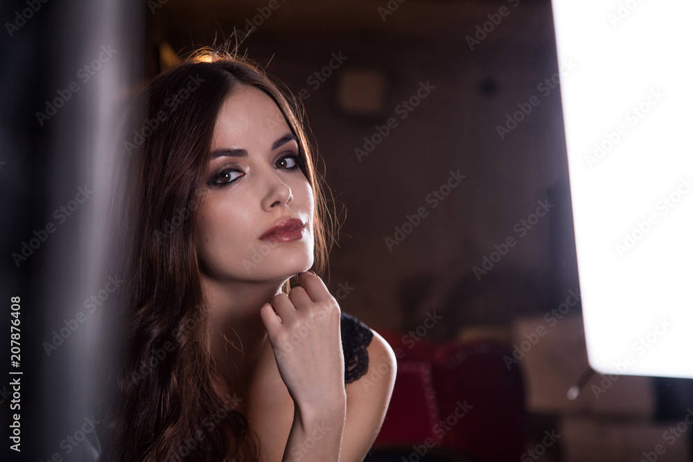 Beautiful girl brunette in black room with light Beautiful girl brunette in black room with light