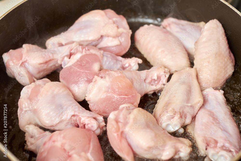 Chicken wings fried in pan with hot oil, homemade food