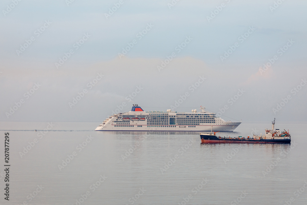 Cruise liner and cargo ship on the sea surface in the Limassol