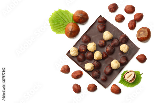 chocolate with hazelnuts and leaves isolated on white background. top view
