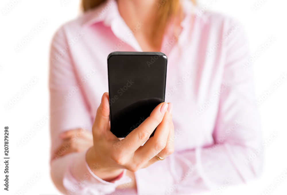 Woman looking at her mobile phone. Isolated on white background.