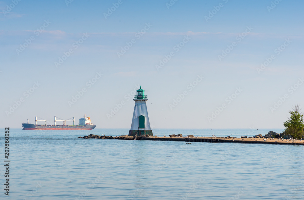Lighthouse and a freight ship