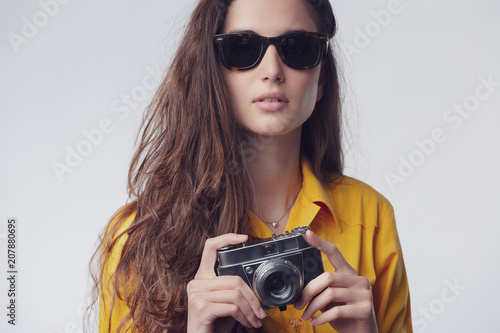 Woman holding photography vintage camera