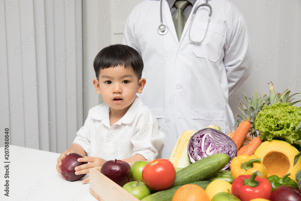 Healthy and nutrition concept. Kid learning about nutrition with doctor to choose how to eat fresh fruits and vegetables.