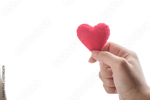 red heart in human hand with dramatic tone