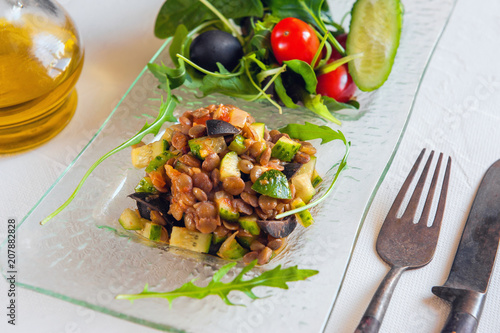 Turkish traditional Lentil salad and a slice of cucumber and green ezogelin, tarhuna. photo