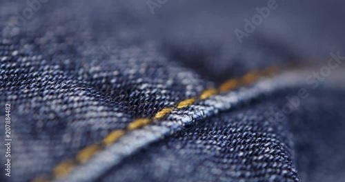 Soft blue background texture made from extreme close up macro rack focus shot of blue jeans cloth, shot with a rack focus moving from front to back and back to front.