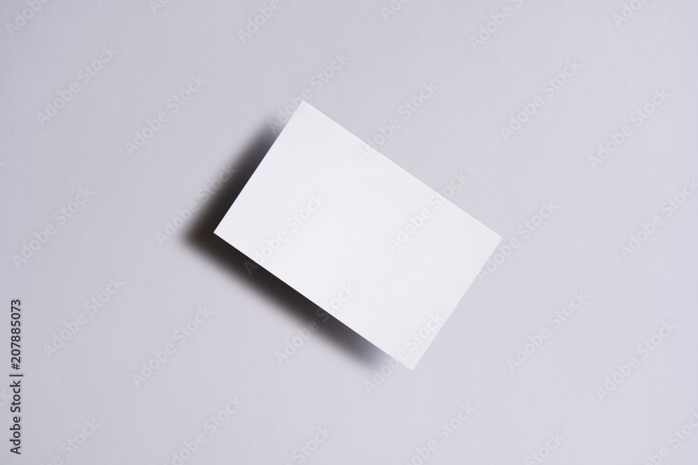 Photo of blank business cards on white. Mock-up for branding identity. For graphic designers presentations and portfolios Photo of blank business cards on white. Mock-up for branding identity. For graphic designers presentations and portfolios