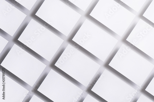 Photo of blank business cards on white. Mock-up for branding identity. For graphic designers presentations and portfolios. business cards stacks arranged in rows at white textured paper background.
