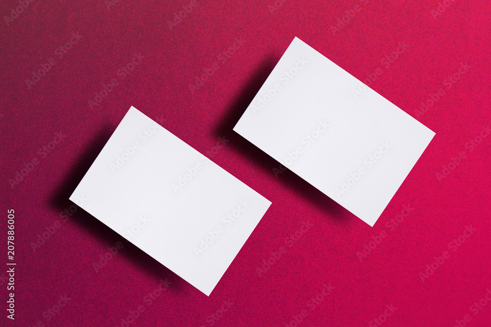Mock up of two horizontal white business cards at pink textured paper background. Mock-up template for branding identity. For graphic designers presentations and portfolios Mock up of two horizontal white business cards at pink textured paper background. Mock-up template for branding identity. For graphic designers presentations and portfolios