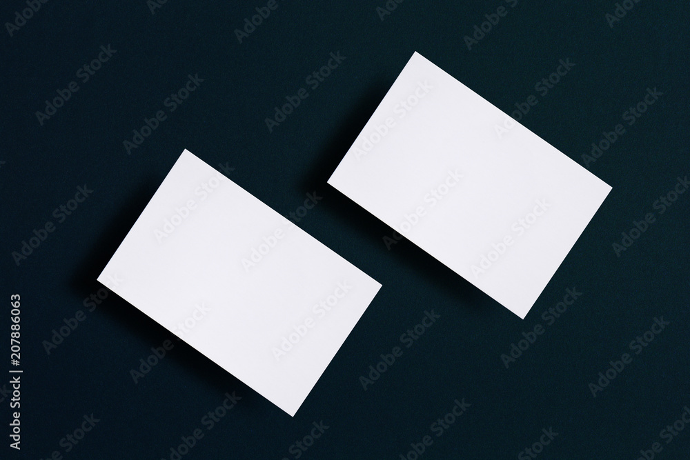 Mock up of two horizontal white business cards at black textured paper background. Mock-up template for branding identity. For graphic designers presentations and portfolios Mock up of two horizontal white business cards at black textured paper background. Mock-up template for branding identity. For graphic designers presentations and portfolios