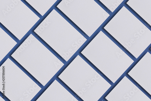 Photo of blank business cards. Mock-up for branding identity. For graphic designers presentations and portfolios. Business cards stacks arranged in rows on blue textured paper background