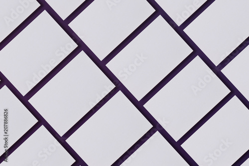 Photo of blank business cards. Mock-up for branding identity. For graphic designers presentations and portfolios. Business cards stacks arranged in rows on blue textured paper background