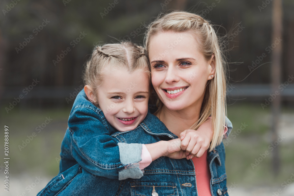 adorable daughter hugging her smiling mother adorable daughter hugging her smiling mother