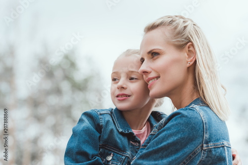 happy family of blonde mother and adorable daughter