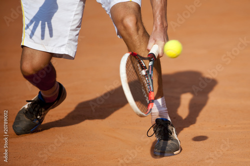 The tennis player puts the ball