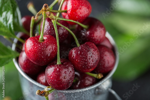 Fresh cherry with water drops on dark stone background. Fresh cherries background. Healthy food concept