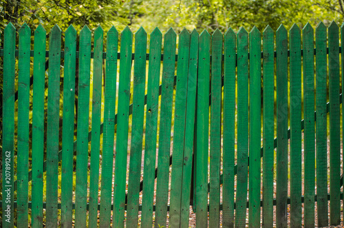 Old green wooden fence in the countryside