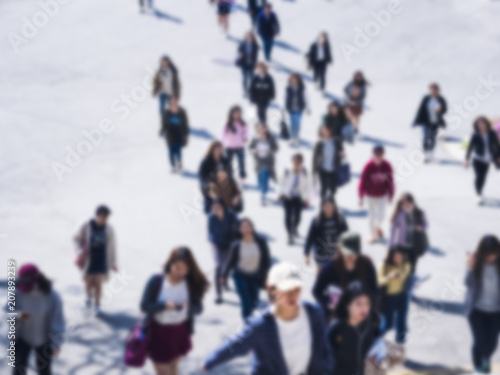 Blur people walking on pedestrian Asian teenager