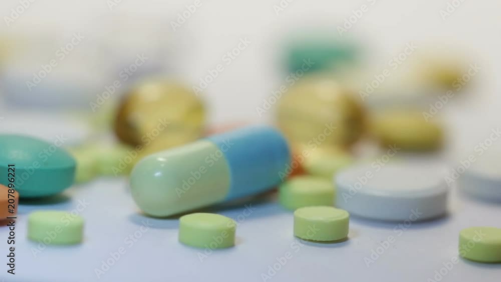 Many different medicines on white table. colorful pills, capsules and dragees Many different medicines on white table. colorful pills, capsules and dragees