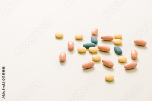 Tablets and capsules over white background