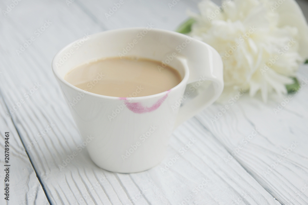 White cup of coffee on a white table with traces of lipstick White cup of coffee on a white table with traces of lipstick
