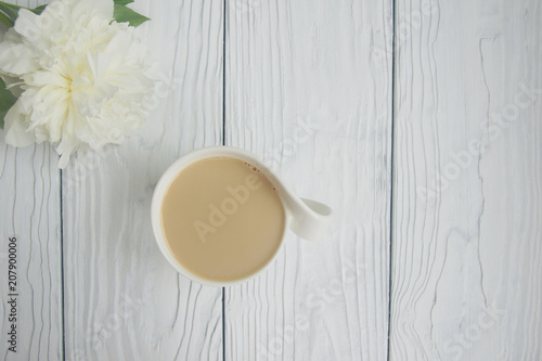 White cup of coffee on a white table  