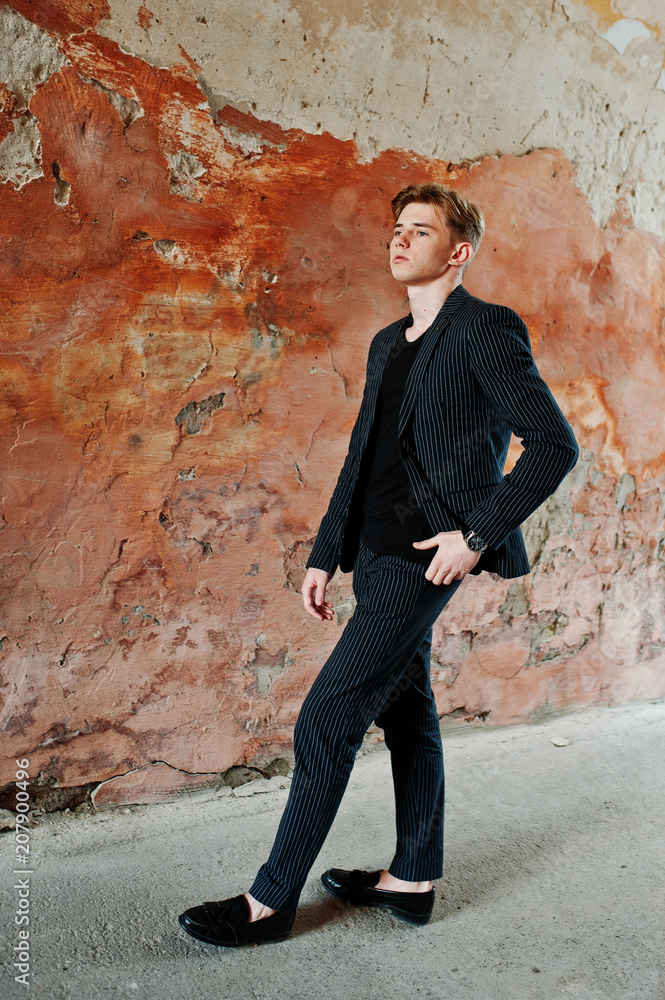 Young stylish macho boy in black jacket posed outdoor of street. Amazing model man. Young stylish macho boy in black jacket posed outdoor of street. Amazing model man.